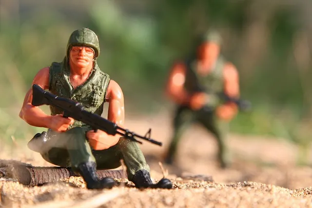 Hands repairing a loose joint on an action figure