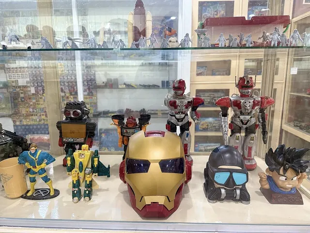 Action figures displayed in a lit glass cabinet