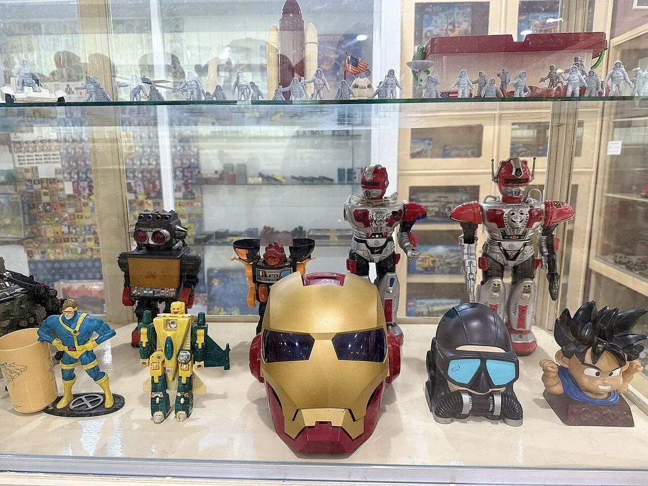 Action figures displayed in a lit glass cabinet