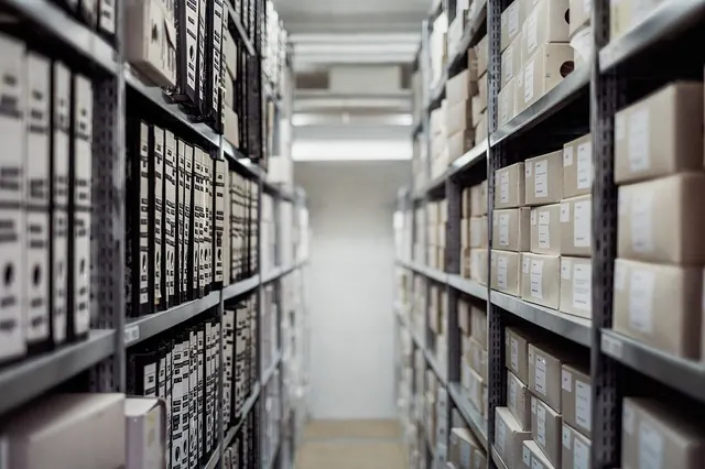 Boxed action figures stored on a closet shelf